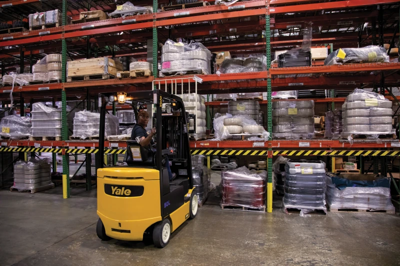 Man backing up Hyster forklift in warehouse