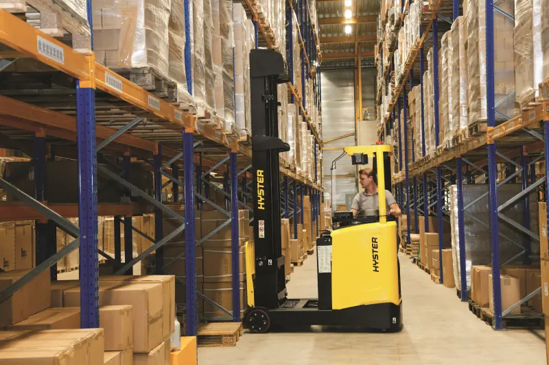 Person using Hyster forklift in warehouse